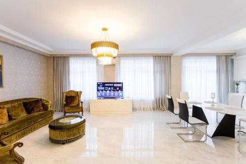 a living room with a couch and a table at Luxury Apartment For Families Or Group of Visitors In City Center I in Tbilisi City