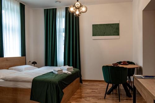 a bedroom with a bed and a table with a chair at Gostišče Pod Kostanji in Dobrna