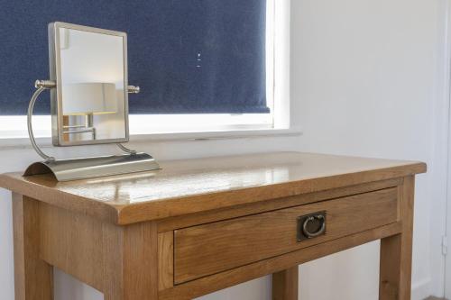 a dressing table with a mirror on top of it at Apters Hill House Dog Friendly With Free Parking in Brixham