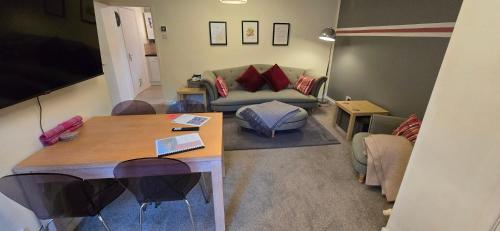 a living room with a couch and a table at Rhubarb Retreat - Stylish House, Sleeps 5, 10 mins to Durham City & Parking & Garden in Gilesgate