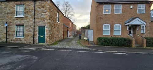 an empty street in front of a brick building at Rhubarb Retreat - Stylish House, Sleeps 5, 10 mins to Durham City & Parking & Garden in Gilesgate