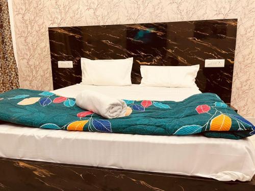 a large bed with a blanket on top of it at Golden palace studio in Ghaziabad