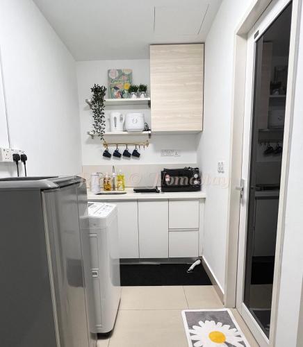 a small kitchen with white cabinets and a sink at SS15 Courtyard Subang Jaya Sunway Home Cinema Projector Studio 120 Inches in Subang Jaya