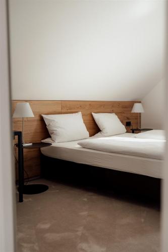 a bedroom with two beds with white pillows at Hotel Dammühle in Marburg an der Lahn