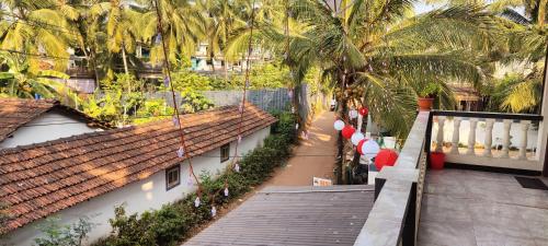 a view of a street from a balcony with palm trees at Antonios Calangute beach in Calangute