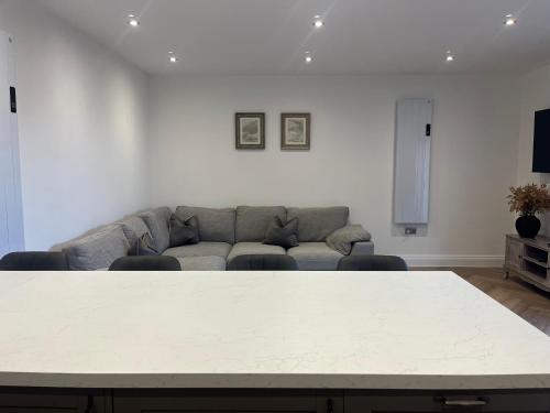 a living room with a table and a couch at Mill House The Lodge in Upwell