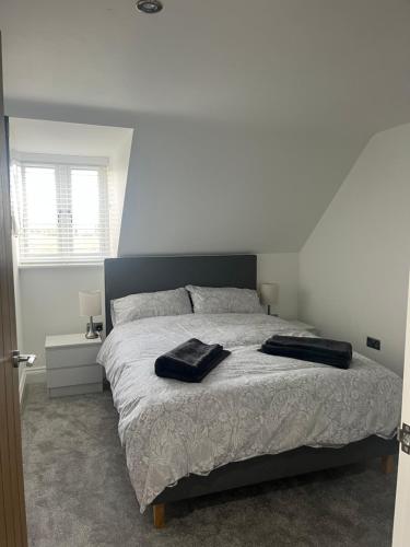 a bedroom with a bed with two towels on it at Mill House The Lodge in Upwell
