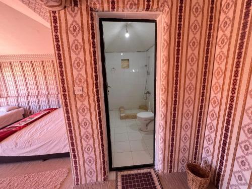 a bathroom with a shower and a toilet in a room at Milky Way Bedouin Camp in Wadi Rum