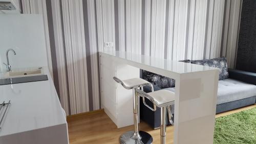 a living room with a white table and a couch at StudioSpanie Apartament Baltic in Gdynia