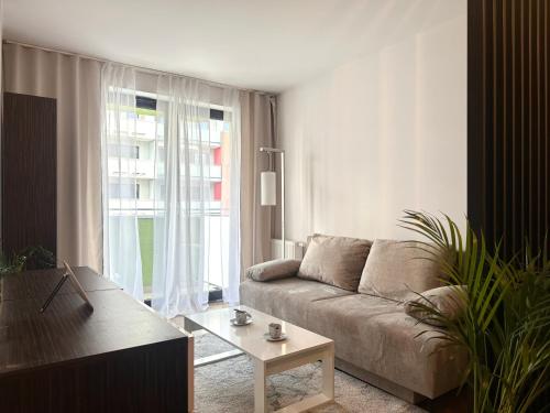 a living room with a couch and a table at Nyska Apartment - Self Check-In 20h - Parking in Wrocław