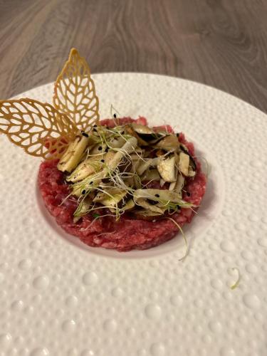 a plate of food with butterflies on top of it at Agriturismo Terra e Cielo in Serra Riccò