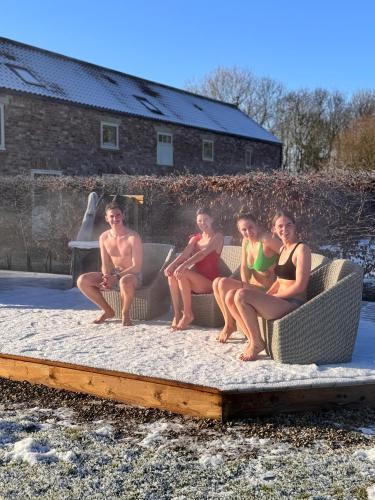 a group of people sitting on a couch at Luxury Barn with sauna near York welcoming families, friends, groups in York