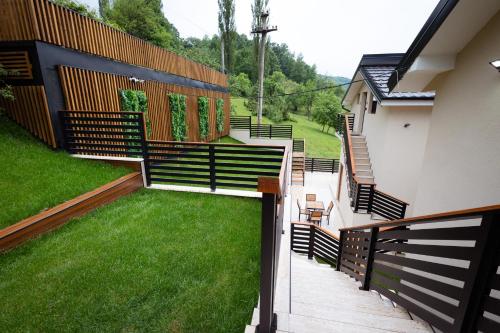 a balcony of a house with a grass yard at Vila Sofija Banja Vrujci in Gornja Toplica