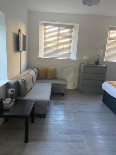 a living room with a couch and a coffee table at The Station Hotel in Alness