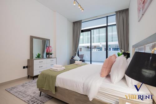 a bedroom with a large bed with a large window at 1-BR Binghatti Rooftop Pool, Gym in Dubai