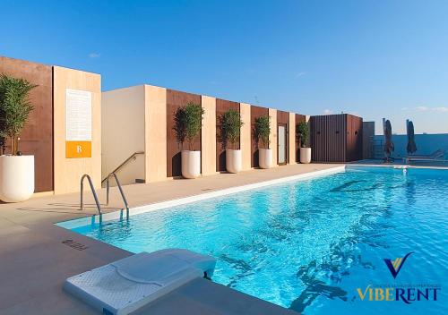 a swimming pool on the side of a building at 1-BR Binghatti Rooftop Pool, Gym in Dubai