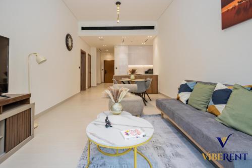 a living room with a couch and a table at 1-BR Binghatti Rooftop Pool, Gym in Dubai