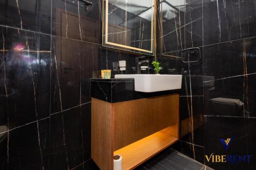 a bathroom with a sink and a mirror at 1-BR Binghatti Rooftop Pool, Gym in Dubai