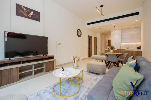 a living room with a couch and a tv at 1-BR Binghatti Rooftop Pool, Gym in Dubai