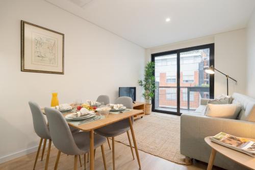 a living room with a table and a couch at Stylish & Bright Flat with Balcony by HostWise in Matosinhos