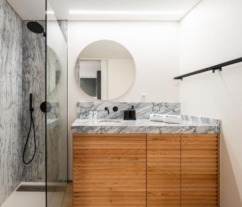 a bathroom with a sink and a mirror at Stylish & Bright Flat with Balcony by HostWise in Matosinhos