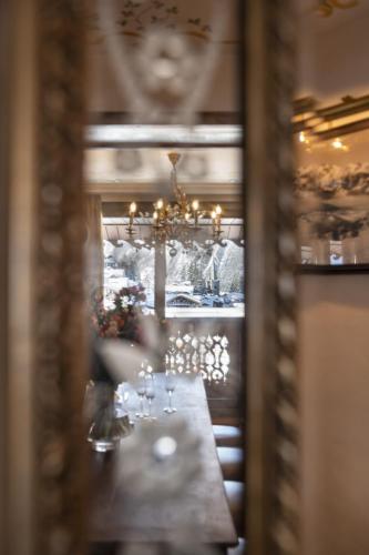 a dining room with a table with wine glasses at Hôtel de la Loze in Courchevel