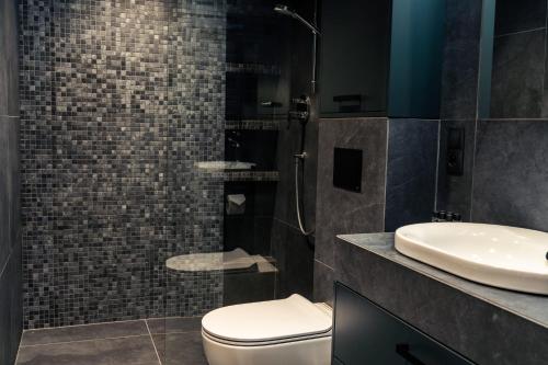 a bathroom with a toilet and a sink at ApartView Plażowa Residence Szczyrk by Rent like home in Szczyrk