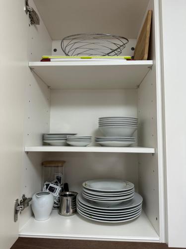 a cupboard filled with plates and dishes at Apartment Sara in Njivice