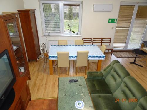 a living room with a table and a couch at Wynajem pokoi Białystok in Białystok