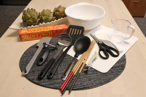 a table with utensils on top of a table at くつろぎのお宿 やわや 花水木 in Toyama