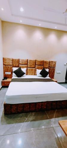 a bedroom with a large bed in a room at Hotel Orio Castle in Ludhiana