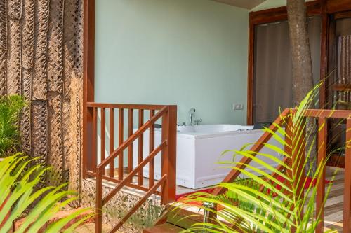a bathroom with a bath tub and a sink at Goa Beach Villa in Agonda