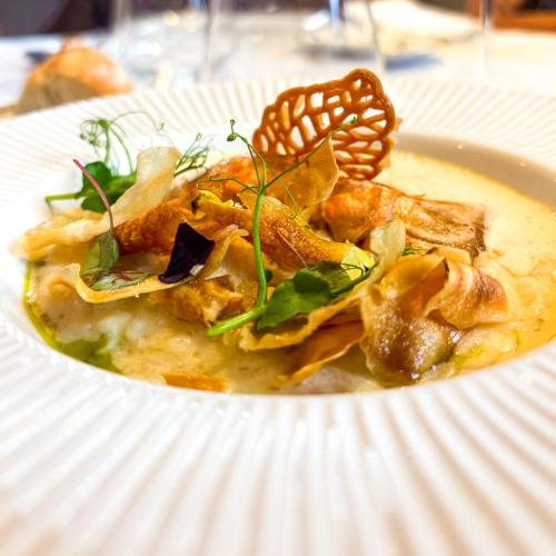 a white plate of food on a table at La Demeure d'Élodie in Épernay
