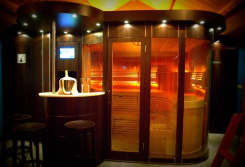 a room with a shower and a bed with stools at La Fiole Ambiance in Ferrières