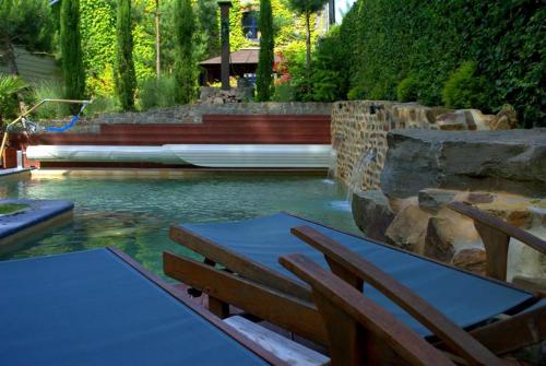 a pool with a table and chairs in the water at La Fiole Ambiance in Ferrières