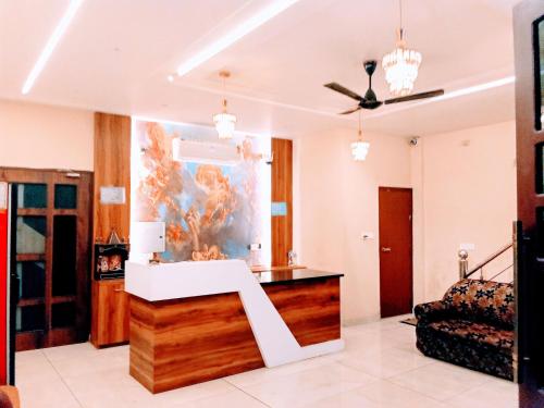a living room with a large aquarium in the middle at Hotel Orio Castle in Ludhiana