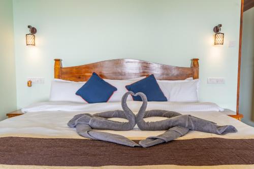 a sculpture of a snake on a bed at Goa Beach Villa in Agonda