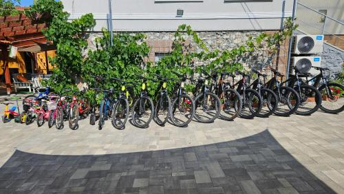 a row of bikes parked next to a wall at E-Tekergők Háza in Bükkzsérc