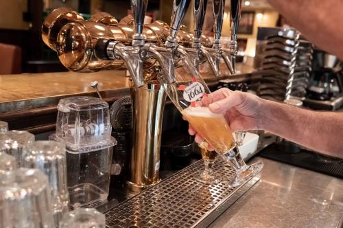 a person is pouring a drink into a glass at ProfilHotels Central in Stockholm