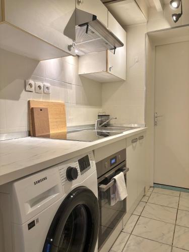 une cuisine avec une machine à laver dans une cuisine dans l'établissement Charming Apartment in Clichy, à Clichy