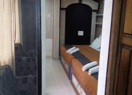 a reflection of a bedroom with a bed in a mirror at Hotel Raj Empire in Mysore