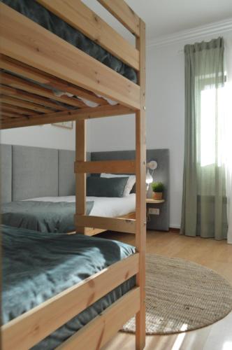 a bedroom with two bunk beds and a rug at Old Village Hostel in Ponte de Lima
