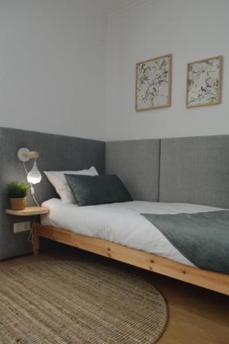 a bedroom with a large bed with a wooden frame at Old Village Hostel in Ponte de Lima