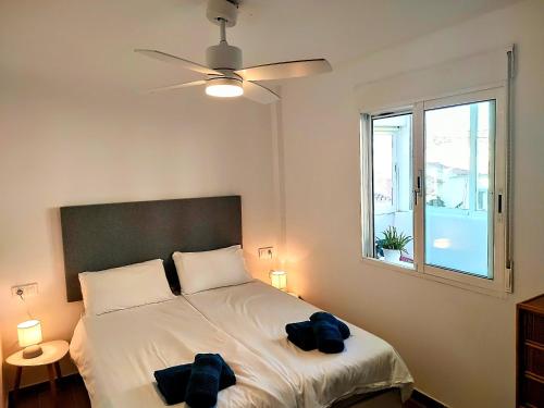 a bedroom with a bed with two bags on it at Spacious Holiday Apartment nearby Arenal Javea in Jávea