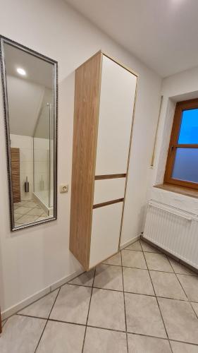 a bathroom with a medicine cabinet and a mirror at Campingplatz Jurahöhe in Pottenstein