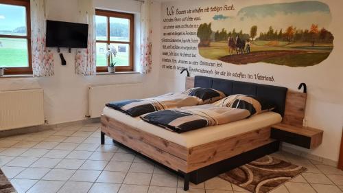 a bed in a room with a poster on the wall at Campingplatz Jurahöhe in Pottenstein