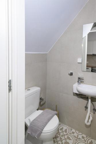 a bathroom with a white toilet and a sink at Kiki House in Rhodes Town