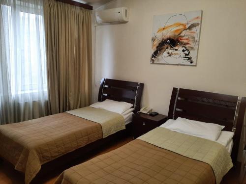 Postel nebo postele na pokoji v ubytování Hotel Grig