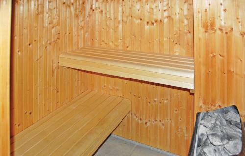 a wooden sauna with a bench in it at Two-Bedroom Apartment In Grasten in Gråsten