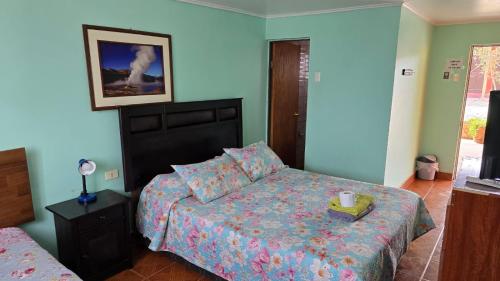 a bedroom with a bed and a night stand with a candle on it at Hostal Mirador in San Pedro de Atacama